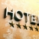 Hotel sign on stucco painted wall. 3d illustration