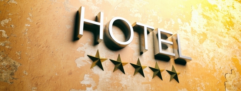 Hotel sign on stucco painted wall. 3d illustration