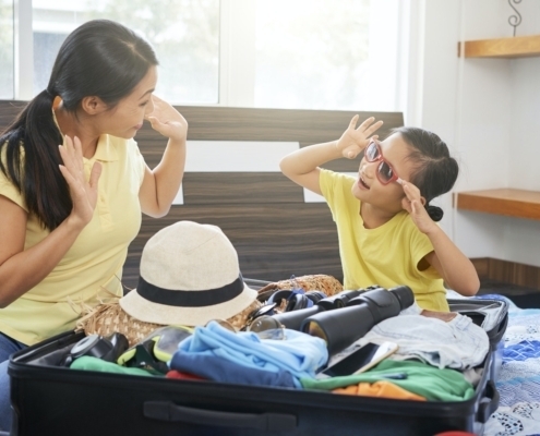 Family packing clothes in suitcase