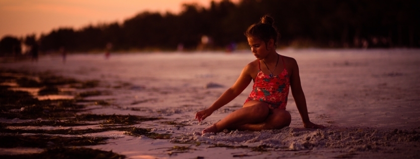Young girl sitting on the beaches of Florida Siesta Keys
