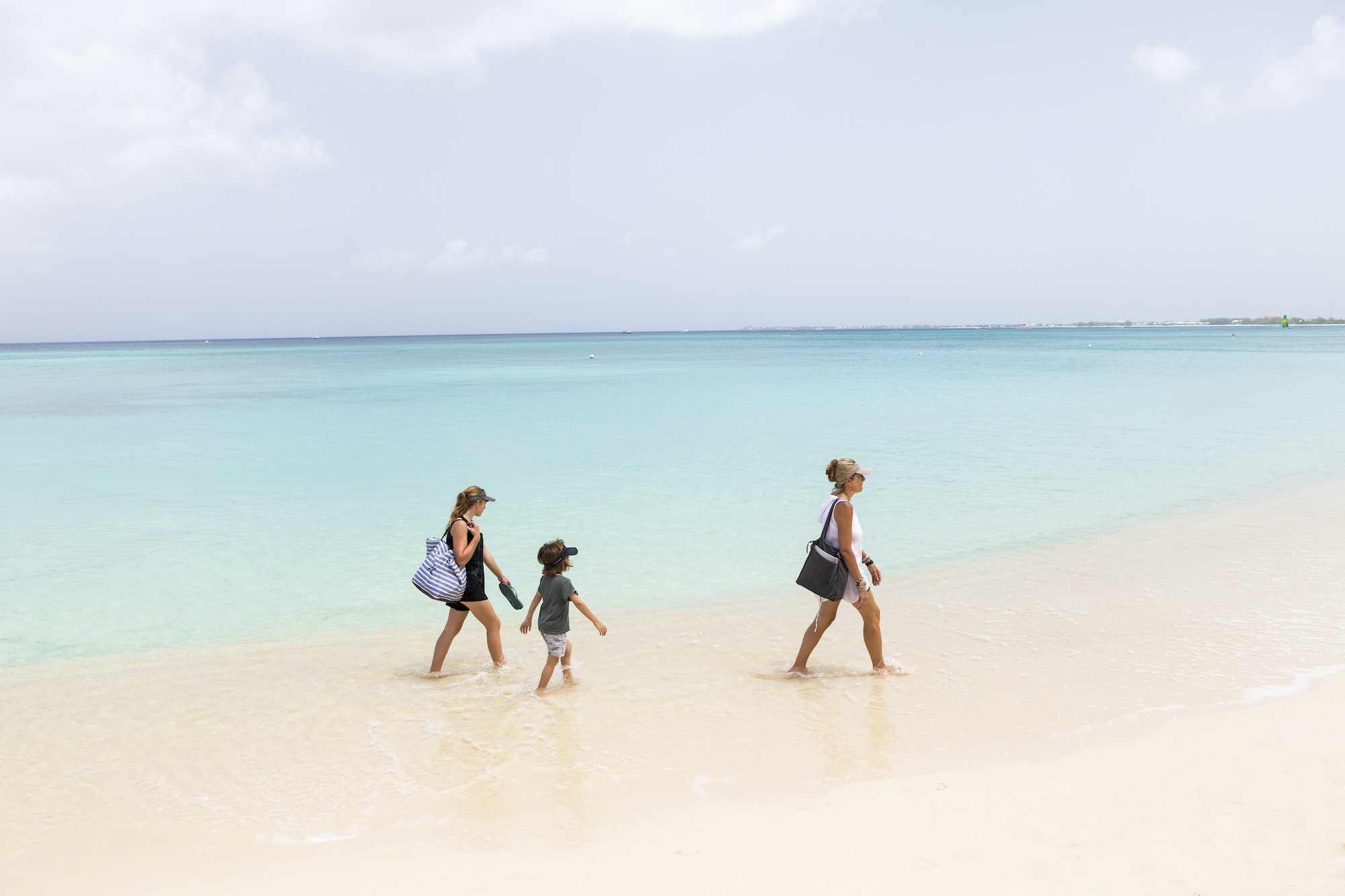 mother and her children walking the beach, Grand Cayman Island