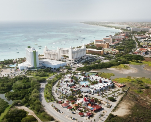 High Angle View Of City By Sea Against Sky At Aruba