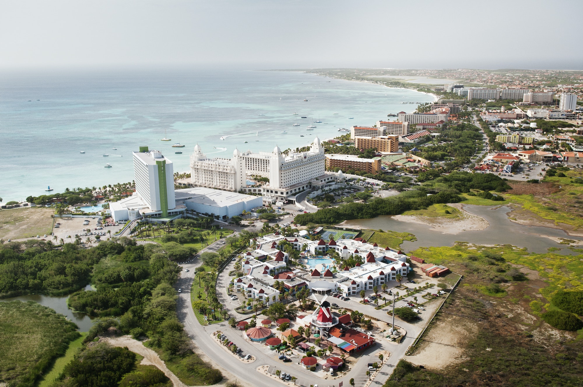 High Angle View Of City By Sea Against Sky At Aruba