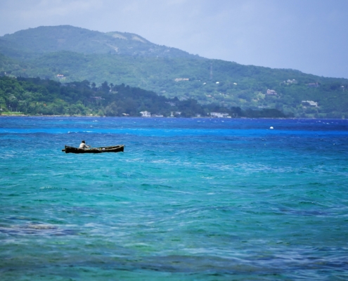 Silhouette of fisherman at stormz sea. Montego bay beach, Jamaica